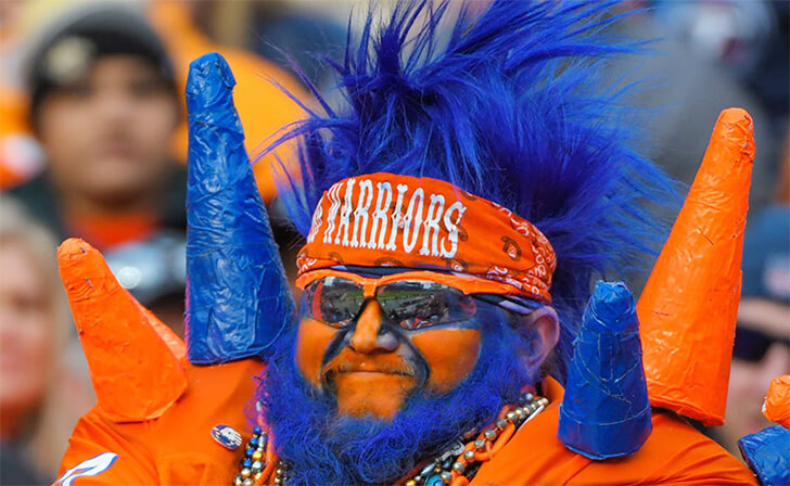 Superfan Goes All Out with Orange Face and Blue Hair for Team Spirit